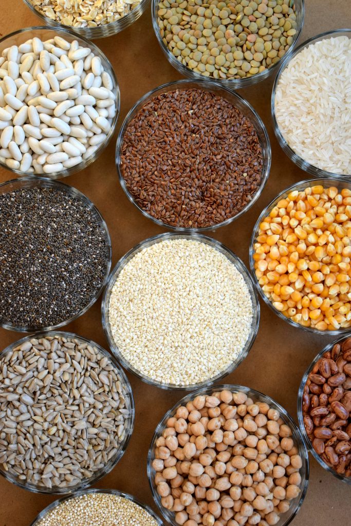 Grains assorted on the table rice quinoa lentil chickpea
