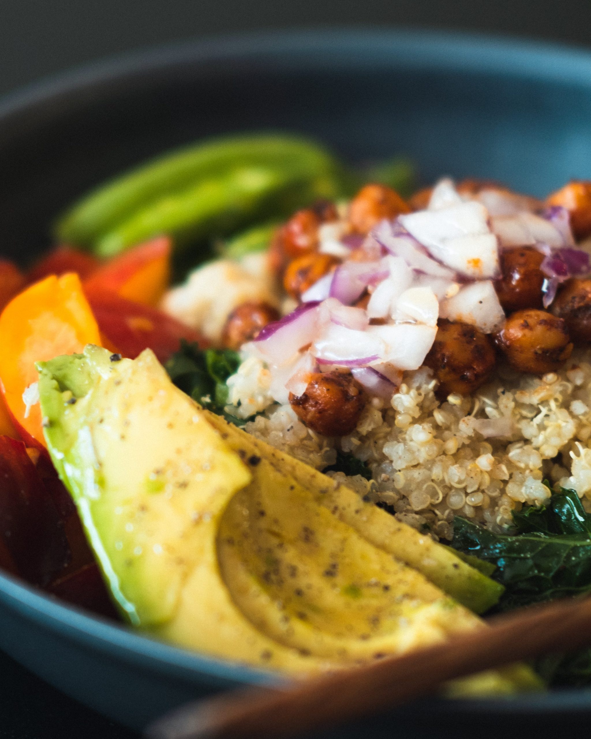 Quinoa bowl with chickpeas, bok choy, sweet potatoes, onions and avocados