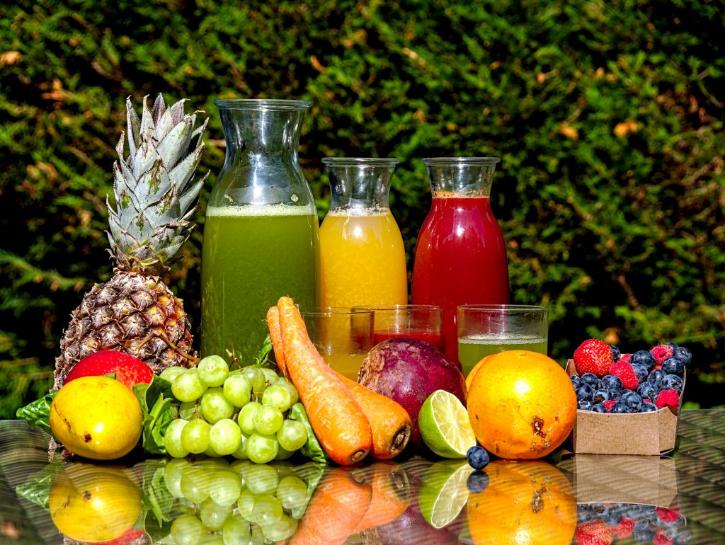 Colorful assortment of fresh fruit juices in glasses, showcasing the variety and vibrancy of juicing benefits