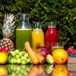 Colorful assortment of fresh fruit juices in glasses, showcasing the variety and vibrancy of juicing benefits