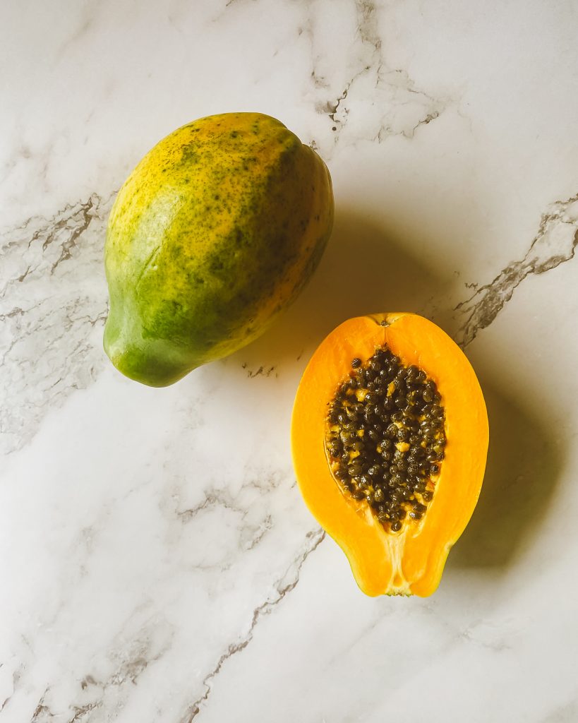 papaya enzyme papayas cut on table