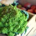 Romanesco broccoli on a wooden cutting board - star of unique veggies blog post